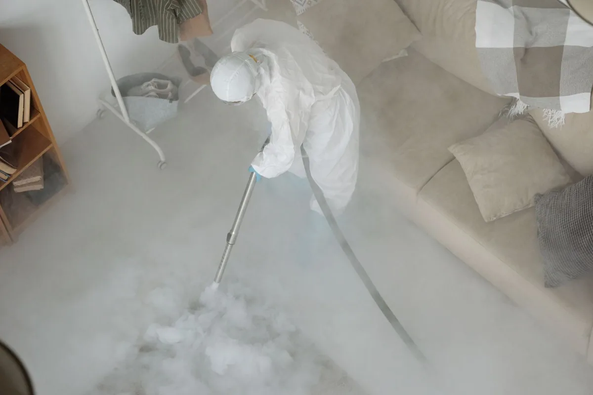 Biohazard cleanup technician in protective equipment, University, FL